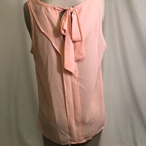 Slightly sheer, coral sleeveless blouse